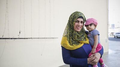 Omaima Labdi, 30, with her daughter Meera, 11 months. Ms Labdi says health care is better in Jordan. Mona Al Marzooqi / The National