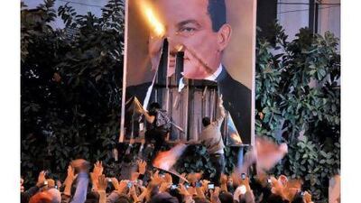 epa02696918 (FILE) A file photo dated 25 January 2011 shows Egyptian protesters tearing down a poster of President Hosni Mubarak during a protest in Alexandria, Egypt. According to local media, an Egyptian court on 21 April 2011 ruled that the name of the former President Hosni Mubarak and his wife Suzanne should be removed from all public facilities in the country. After nearly 30 years in power, Mubarak was forced to step down on 11 February following 18 days of nation-wide protests. EPA/AHMED YOUSSEF *** Local Caption *** 02696918.jpg