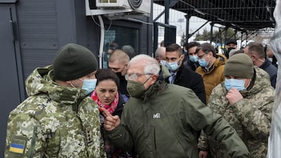 Josep Borrell, centre, visits a border crossing between Ukrainian government-held territory and an area of Russian separatist control. EPA