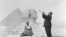American jazz musician Louis Armstrong plays the trumpet for his wife, Lucille, before the Sphinx and Pyramids of Giza, January 1961. Photo: Bettmann Archive
