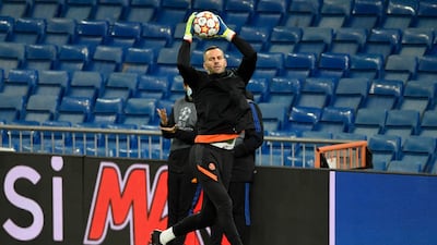 Inter Milan goalkeeper Samir Handanovic jumps for the ball during a training session in Madrid. AFP