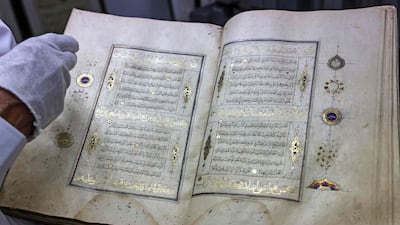Librarian Khader Salameh restores a gilded copy of the Quran that dates back to the 16th century