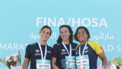 Adrianna Bridi celebrates her success in Abu Dhabi with Rachele Bruni, left, and Ana Marcela Cunha, right. Image courtesy of Abu Dhabi Sports Council