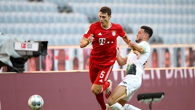 Benjamin Pavard of Bayern Munich is challenged by Ramy Bensebaini of Borussia Monchengladbach. EPA