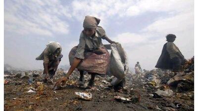 Rag pickers collect scraps from a dump on the outskirts of Hyderabad, southern India.