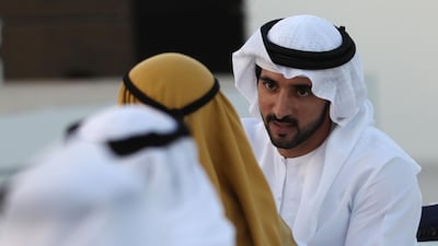 Dubai's Crown Prince Sheikh Hamdan bin Mohammed bin Rashid Al-Maktoum (R), is pictured during a ceremony presenting the new logo of Dubai Airoprt, in Dubai, on February 13, 2019. / AFP / KARIM SAHIB