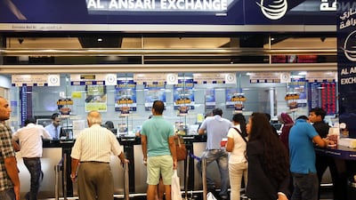 Expats queue to send money home at the Mall of the Emirates branch of Al Ansari Exchange. Satish Kumar / The National