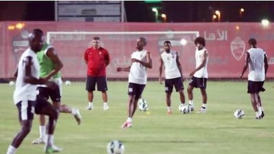 New Al Ahli coach Cosmin Olaroiu, in red, watches as he gets acquainted with his team during the first training session. The Romanian says now is the time he must understand how his players ‘play and how they train ... I have to change some things but not totally’.