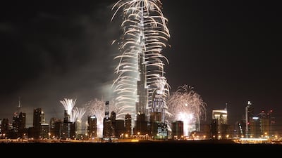 Fireworks cascade from Burj Khalifa as the bells toll on New Year's Eve. Pawan Singh / The National