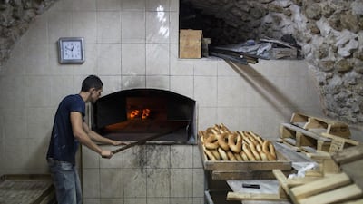 A Palestinian man, Makes Ka’aek at his bakery in the Old City of Jerusalem, during Ramadan.