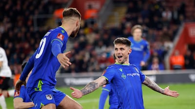 Grisby's Gavan Holohan, right, celebrates with his teammates after scoring his side's second goal during the English FA Cup fifth round soccer match between Southampton and Grimsby Town at St Mary's Stadium in Southampton, England Wednesday, March 1, 2023. (AP Photo / David Cliff)