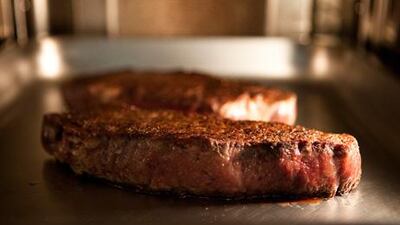 After caramelising the outside in a hot frying pan, and before cooking it gently at 60°C for at least an hour.