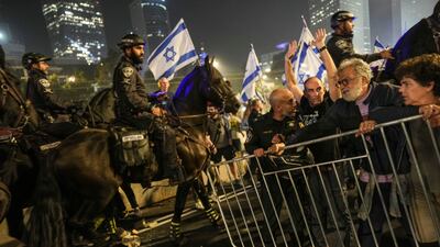 Israeli police try to push back protesters from a main road in Tel Aviv. AP