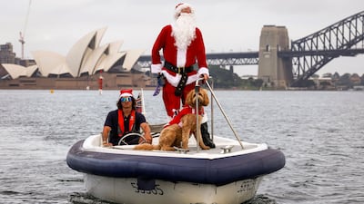 A man dressed as Santa Claus in front of the Sydney Opera House, as part of Christmas Day celebrations for the annual Sydney to Hobart yacht race. AFP