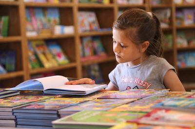 A child at a book fair in Gaza run by affiliate the Tamer Institute.