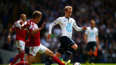 Alex Kacaniklic, left, of Fulham tackles Christian Eriksen of Tottenham Hotspur during their Premier League match at White Hart Lane on April 19, 2014, in London, England. Clive Rose / Getty Images
