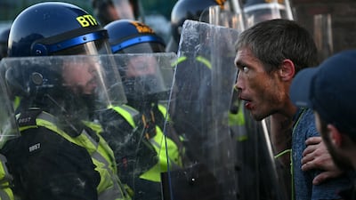 Police and demonstrators at a protest in Southampton, southern England, over the circumstances of the stabbing death of student Henry Nowak last December. AFP