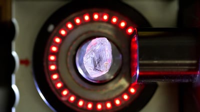 An unpolished natural diamond is scanned by a laser machine before being cut into two segments. Andrey Rudakov / Bloomberg