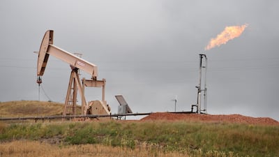 Pump jacks and a gas flare near Williston, North Dakota. US shale’s abundant production is a counterbalance to Opec’s supply cuts.. AFP