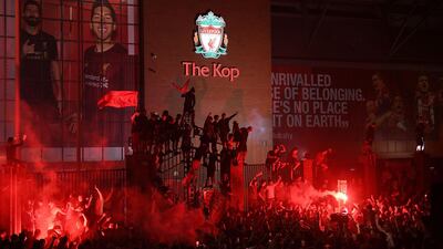 Fans celebrate at Anfield after Liverpool were crowned Premier League champions without kicking a ball on Thursday as Chelsea's 2-1 win over Manchester City ended the Reds' 30-year wait to win the English title. AFP