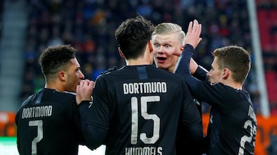 Dortmund's Jadon Sancho celebrates scoring their third goal with teammates. Reuters