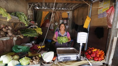 Teodora Martinez poses in her grocery shop in Gosen City. Martinez was one of the original founders of the market after emigrating from the highland city of Huancayo. Mariana Bazo / Reuters
