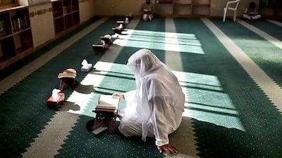 A man reads the Quran during afternoon prayers at a mosque in Abu Dhabi in the Holy Month of Ramadan. Silvia Razgova / The National