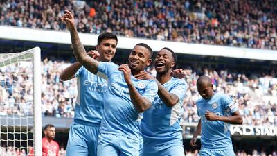 Gabriel Jesus celebrates with teammates after scoring for Manchester City. PA