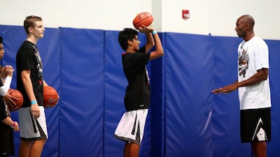 LA Lakers NBA player Kobe Bryant (R) leads a training session at the Gems American Academy in Abu Dhabi on September, 26, 2013. AFP