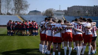 Russia's, left, and Crimea's, right rugby teams gather onto the pitch prior to their match on Saturday. Filippo Monteforte / AFP / March 15, 2014