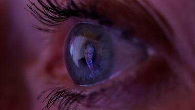 Britain's Prime Minister Boris Johnson is reflected in a woman's eye as she watches his address in Manchester, Britain. Reuters