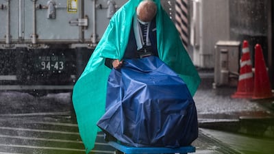 A maintenance worker member battles heavy rain in Tokyo. AFP