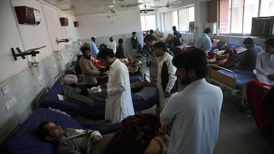 Rescuers pick their way through rugged terrain and pockets of Taliban insurgency in the search for survivors after a massive earthquake hit Pakistan and Afghanistan. Hasham Ahmed / AFP Photo