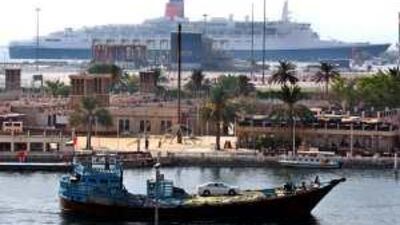 The Queen Elizabeth 2, pictured in the background at its berth in Port Rashid Dubai, where it will remain until its future is decided.