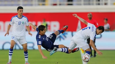 Uzbekistan's Davronbek Khashimov in action with Muto. Reuters