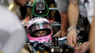 McLaren driver Jenson Button of Britain sits in his car during the second practice session of the Abu Dhabi F1 Grand Prix at the Yas Marina circuit in Abu Dhabi November 21, 2014. REUTERS/Caren Firouz