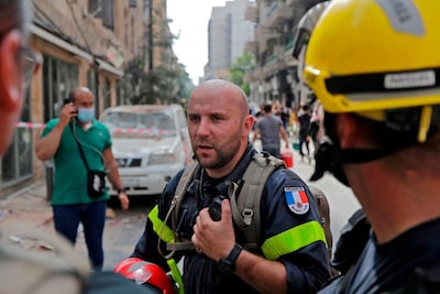 French rescuers work in Beirut's Gemayzeh neighbourhood, damaged by a blast in the Lebanese capital's port three days earlier, that ravaged entire neighbourhoods and left scores of people dead or injured. / AFP / JOSEPH EID