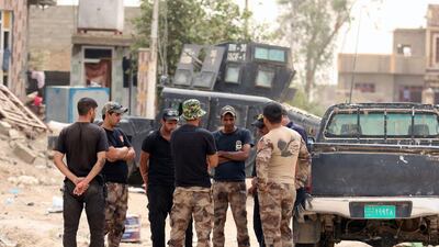 Iraqi counter terrorism forces gather next to their vehicles in Fallujah's southern Shuhada area as they patrol an area they retook from the Islamic State group.