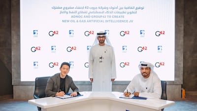 Peng Xiao, chief executive of G42, left, and Omar Al Suwaidi, an Adnoc executive, right, during the signing ceremony with Dr Sultan Al Jaber. Courtesy Adnoc