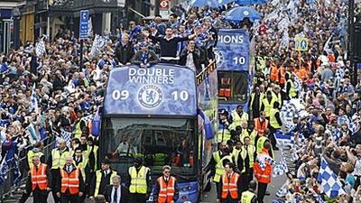Chelsea players react to fans' cheers during their victory bus parade in London yesterday.
