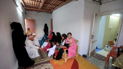 Salima Ali Al Farsi, seated right, with her children and grandchildren in their home in Abu Dhabi, which dates from about 1969 and is one of the oldest houses in the city. Ravindranath K / The National