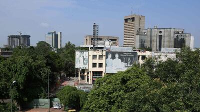 Commercial buildings in New Delhi on September 12 and on October 29. AFP