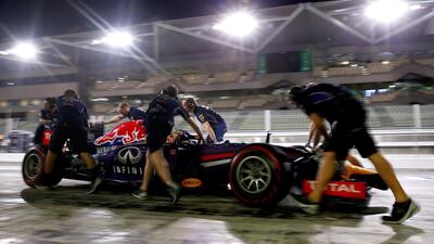 Carlos Sainz Jr. of Spain and Infiniti Red Bull Racing returns to the garage during day one of Formula One testing at Yas Marina Circuit on November 25, 2014 in Abu Dhabi, United Arab Emirates. (Photo by Dan Istitene/Getty Images)