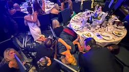 Guests take cover after gunshots were heard at the White House Correspondents' dinner. Reuters