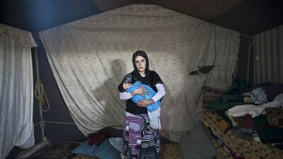 Wadhah Hamada, 22, holds her son Ra'fat, 10 days old.