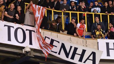 Arsenal supporters dismantle the large 'Tottenham Hotspur' sign inside White Hart Lane on Wednesday night after Arsenals League Cup win over Spurs. Ben Stansall / AFP