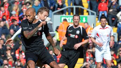 Thierry Henry, front left, in action against Lucas Leiva. Peter Powell / EPA
