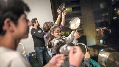 Members of the Hajj family bang pots and pans on their balcony of the flat in Sassine, Beirut, to express their anger at Lebanon's political leaders. Jacob Russell for The National