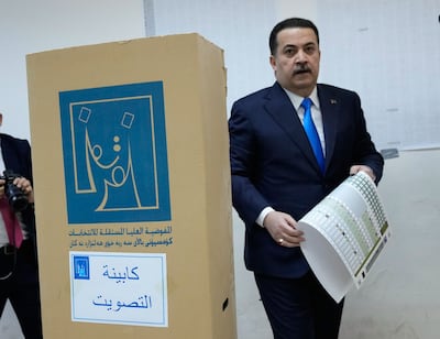 Iraqi Prime Minister Mohammed Shia Al Sudani holds a ballot paper to cast his vote in Baghdad. But can he cling on to power? EPA