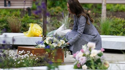 Catherine, Duchess of Cambridge, lays flowers at the official opening of the Glade of Light memorial in Manchester on Tuesday. The memorial commemorates the victims of the May 2017 terrorist attack at Manchester Arena. AFP